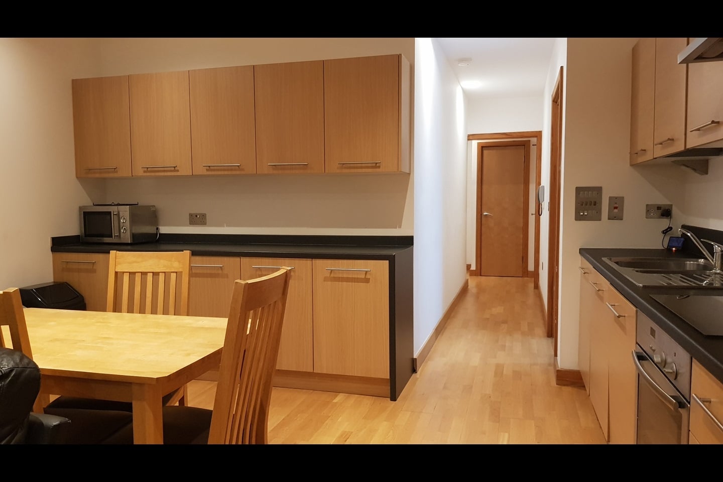 Fitted kitchen and dining space in the example apartment